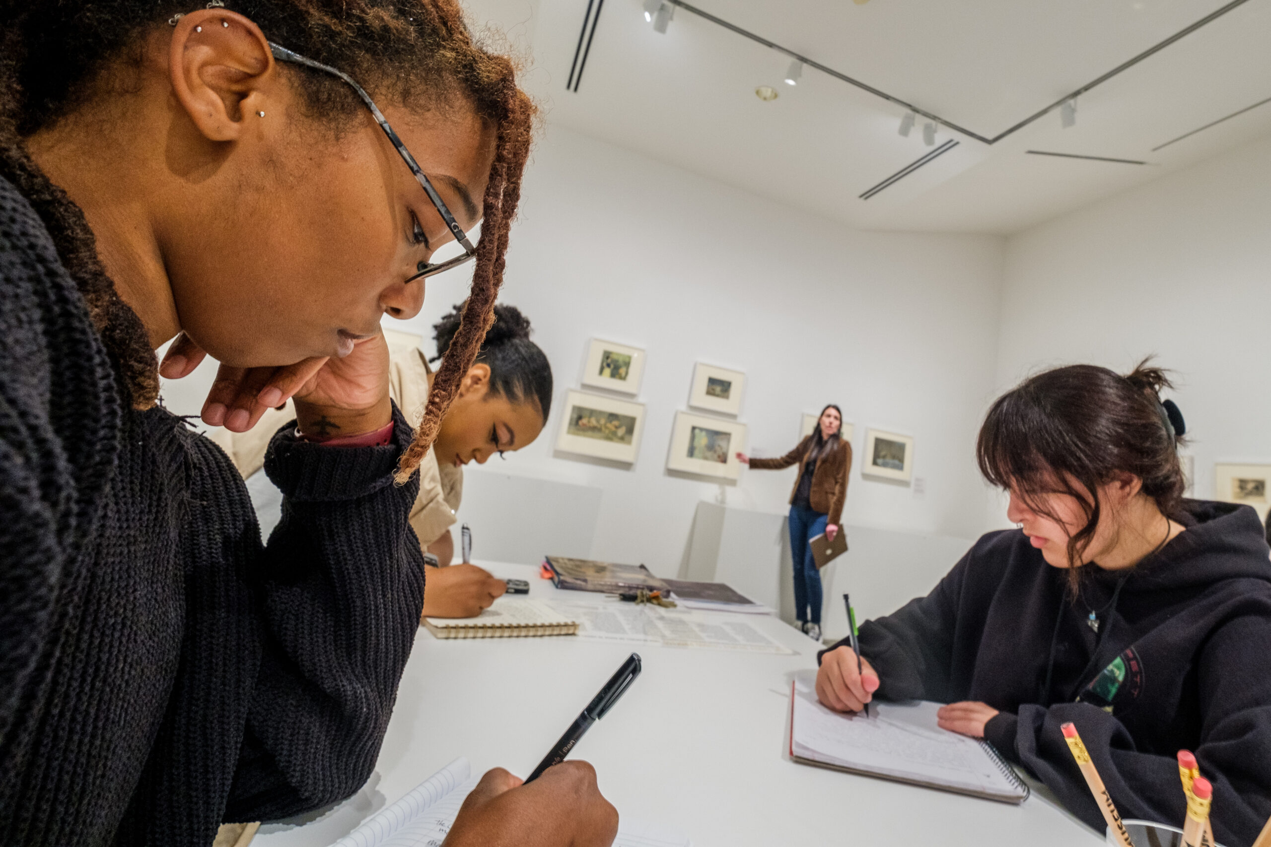 Students draw at a table at UNCG's Weatherspoon Art Museum.