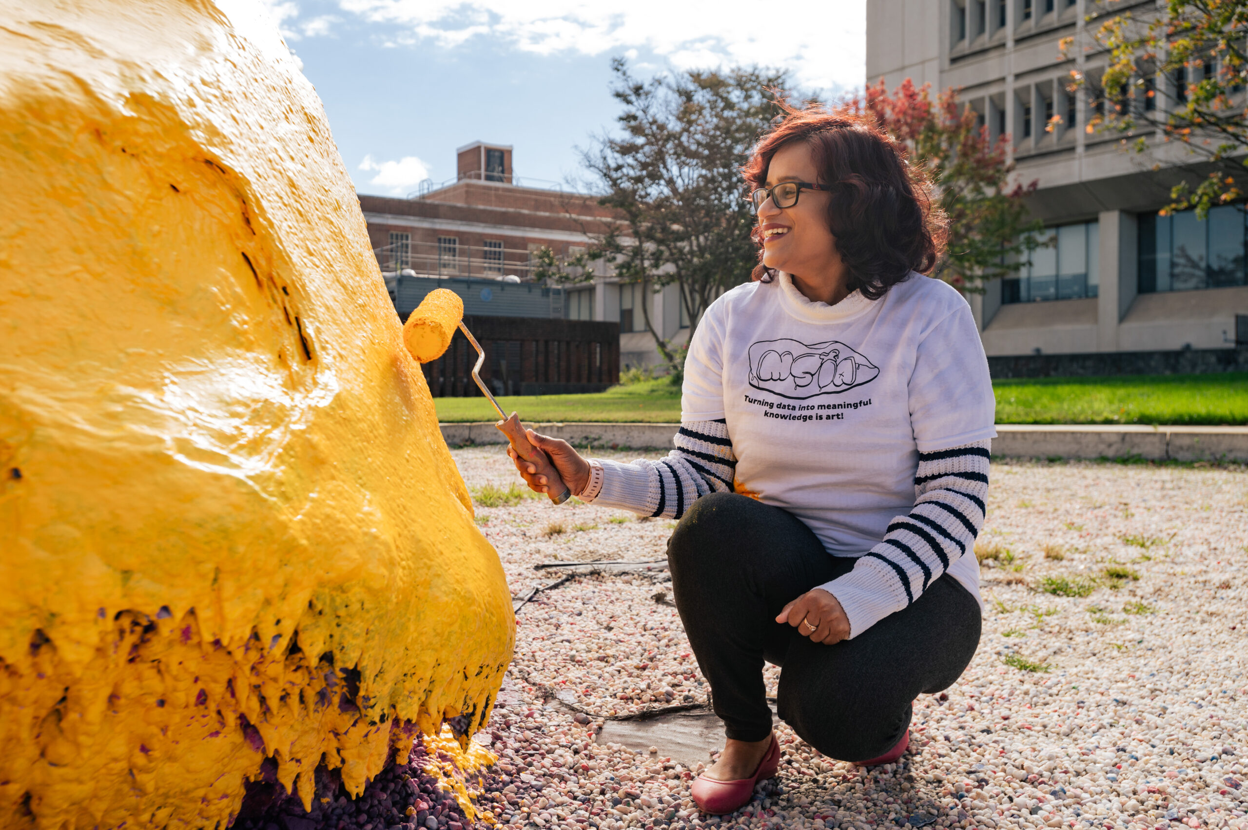 Dr. Prashanti Manda painting the Rawk at UNCG.