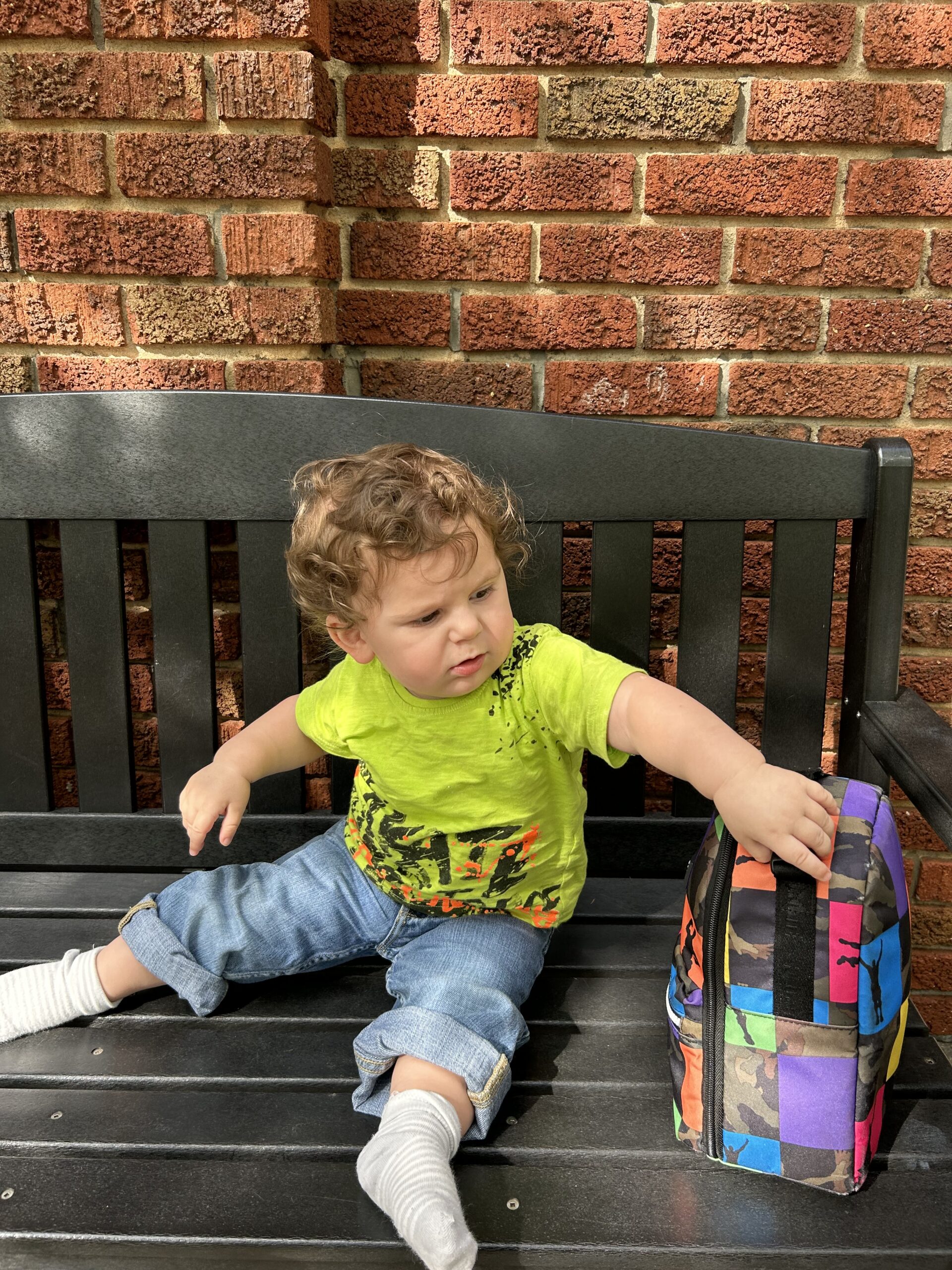 A child sits on a bench.