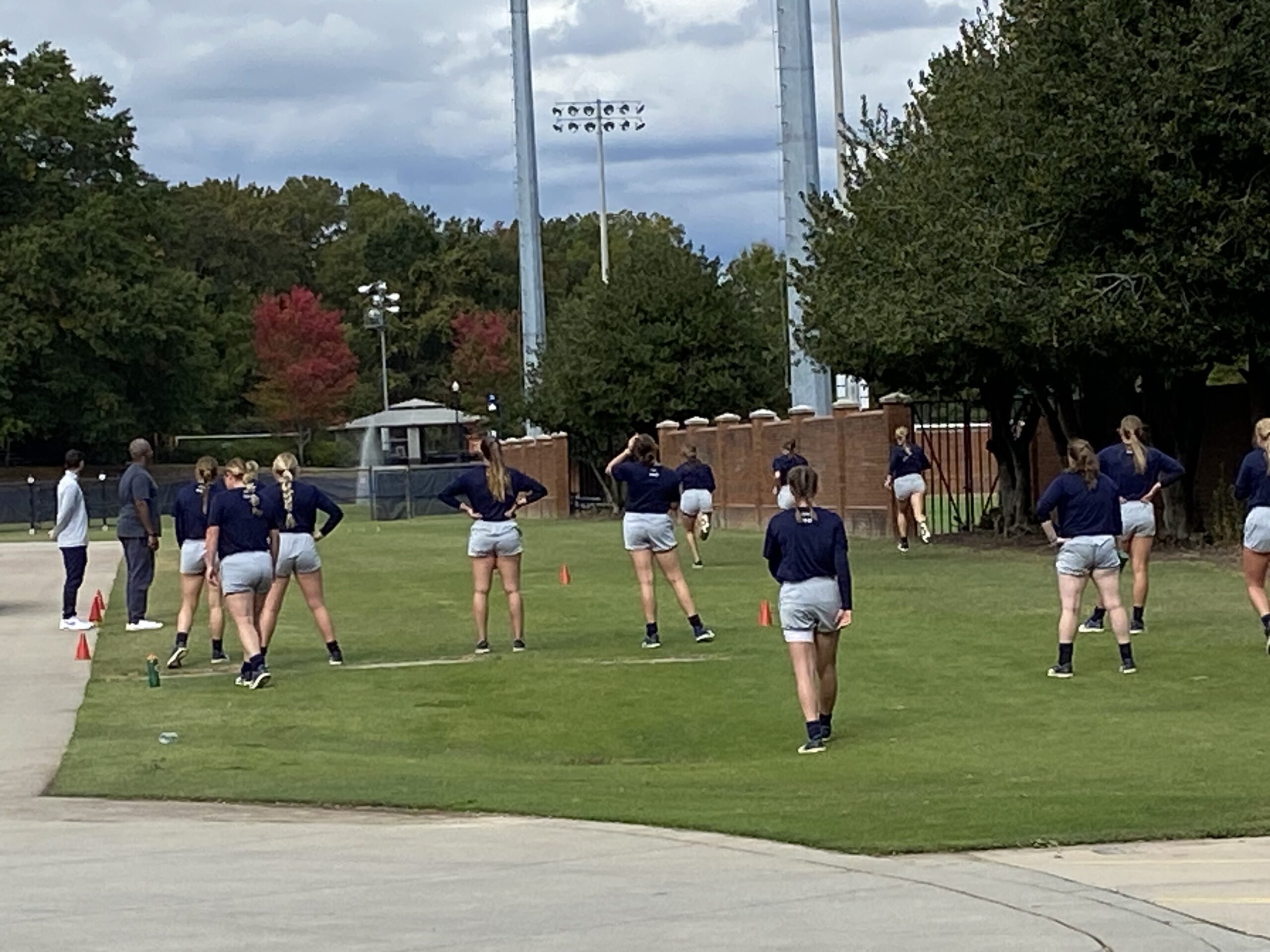 Student athletes practice on a field.