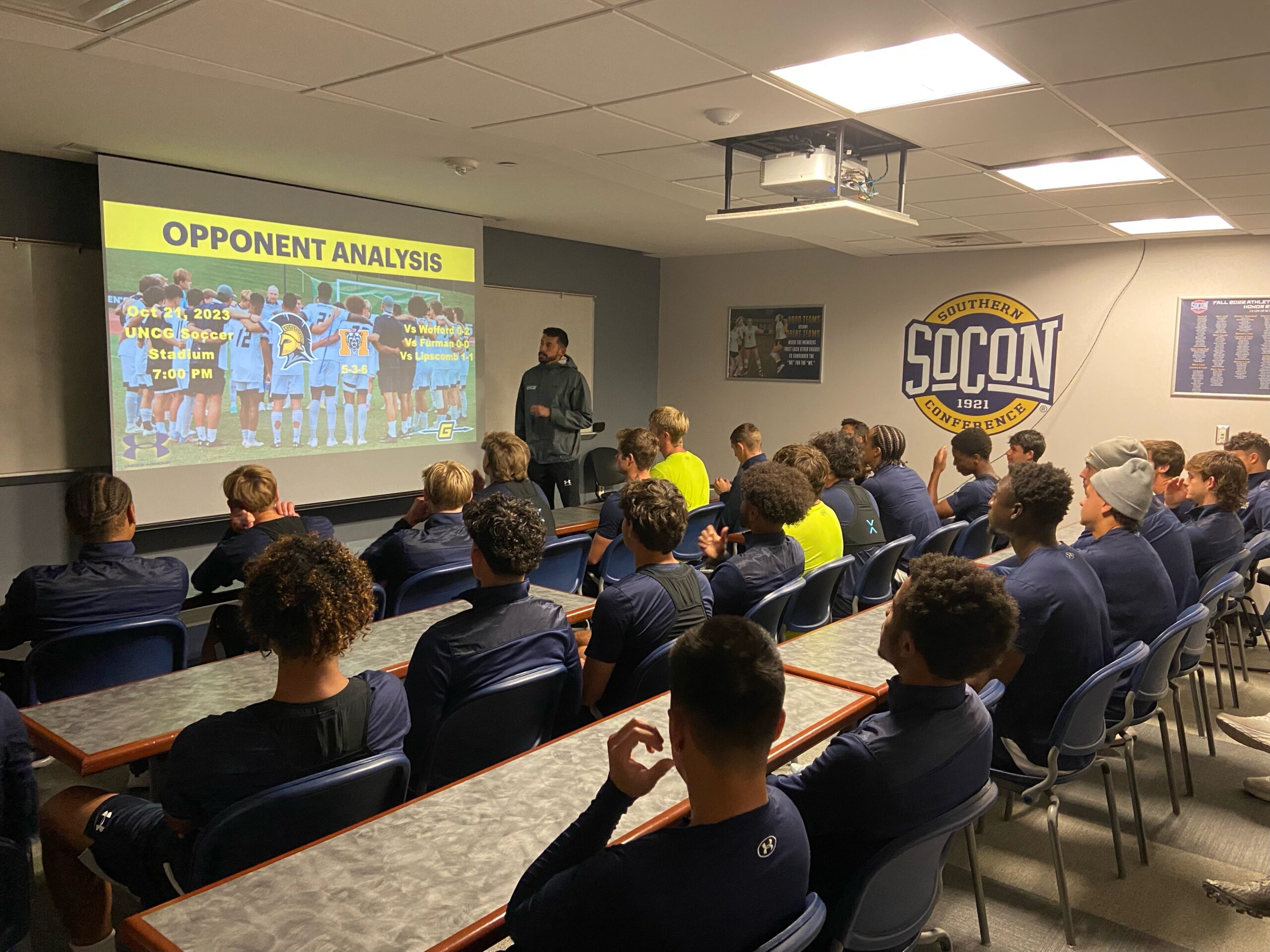 UNCG men's soccer team reviewing oponent analysis.