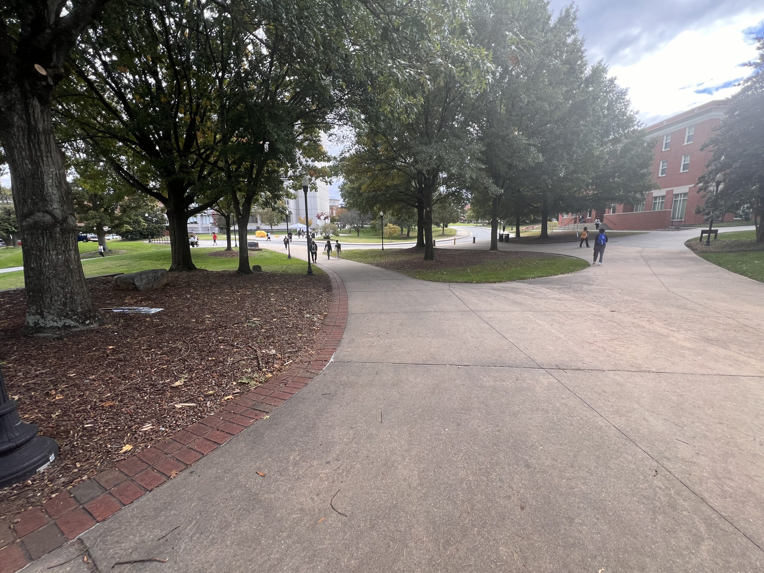 Students walk along a path at UNCG campus.