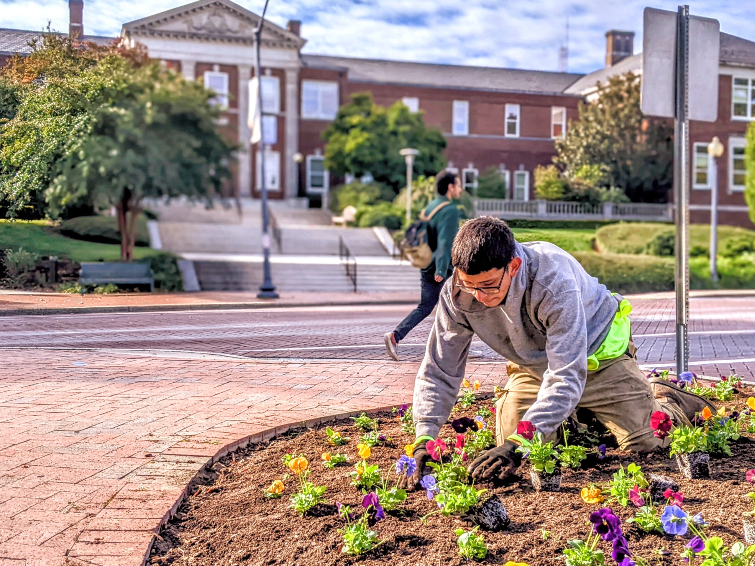 UNCG staff member plants flowers