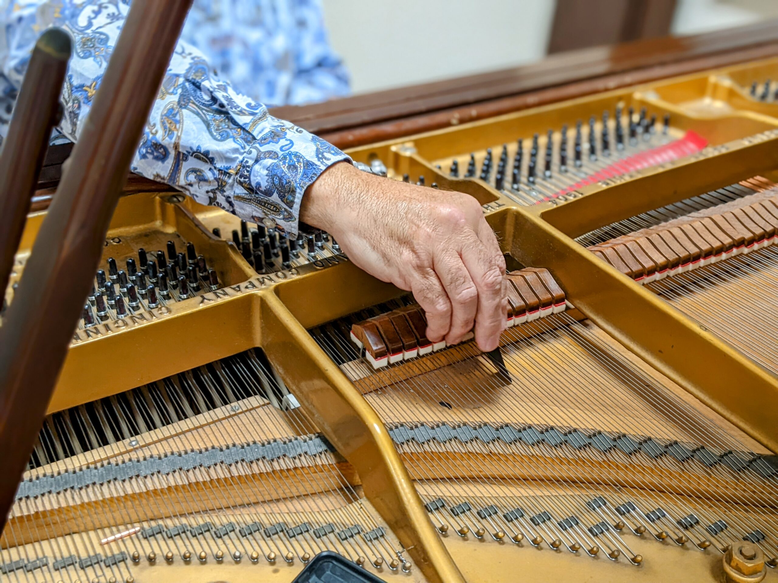 Close up on a person tuning a UNCG piano.