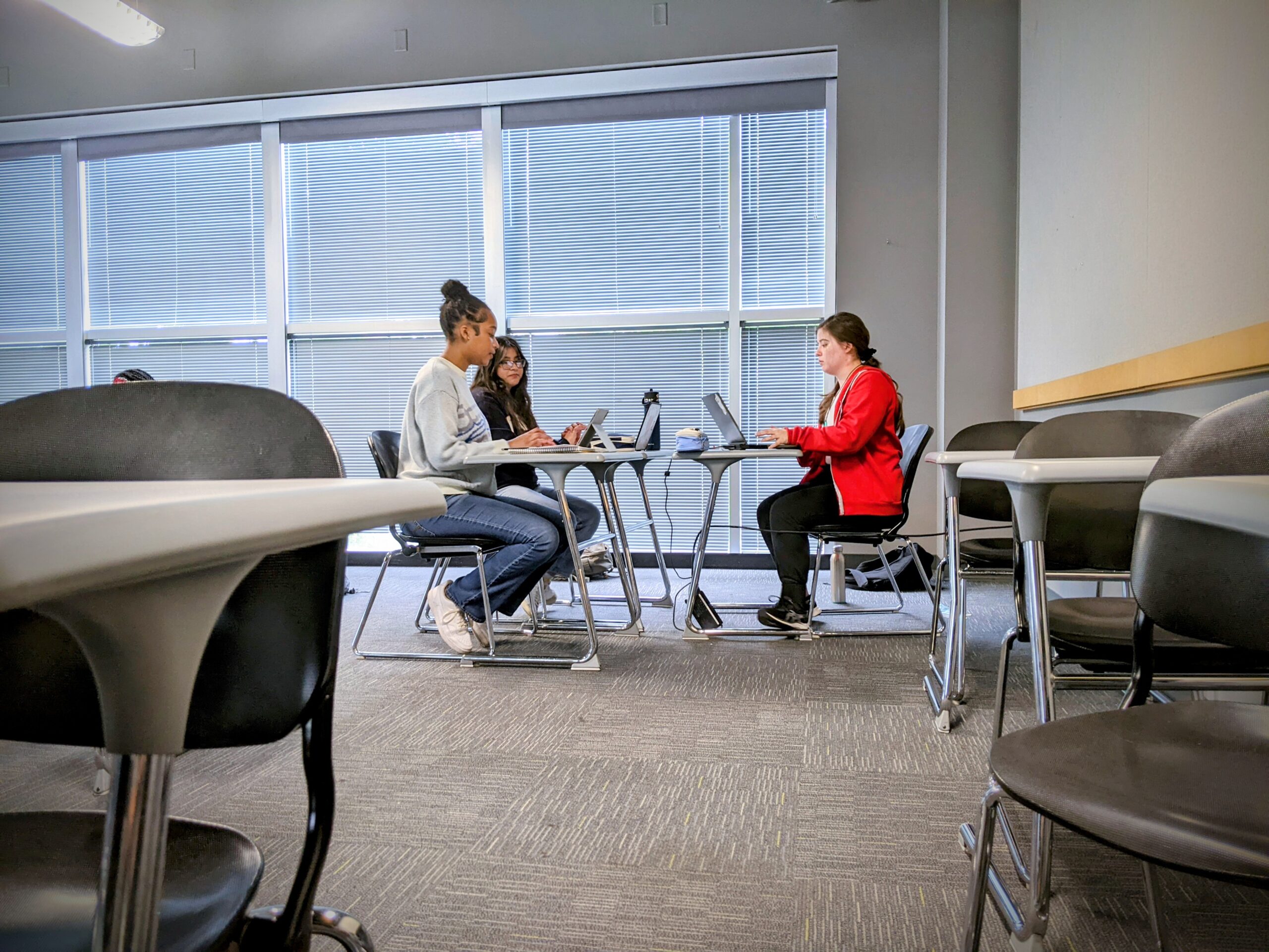 Three students study in a lounge.