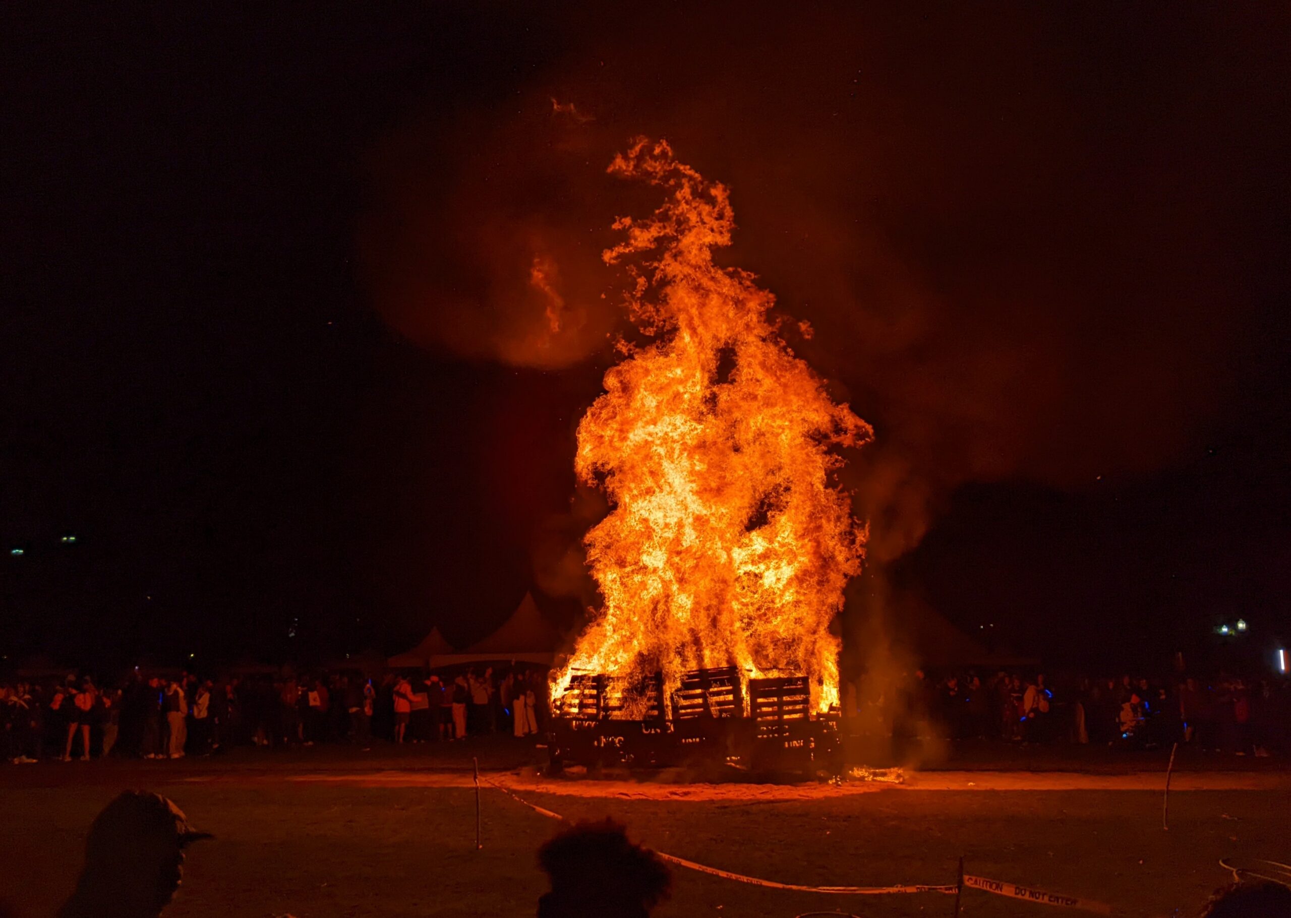 A huge bonfire burns on Kaplan Commons to kick off homecoming 2023.