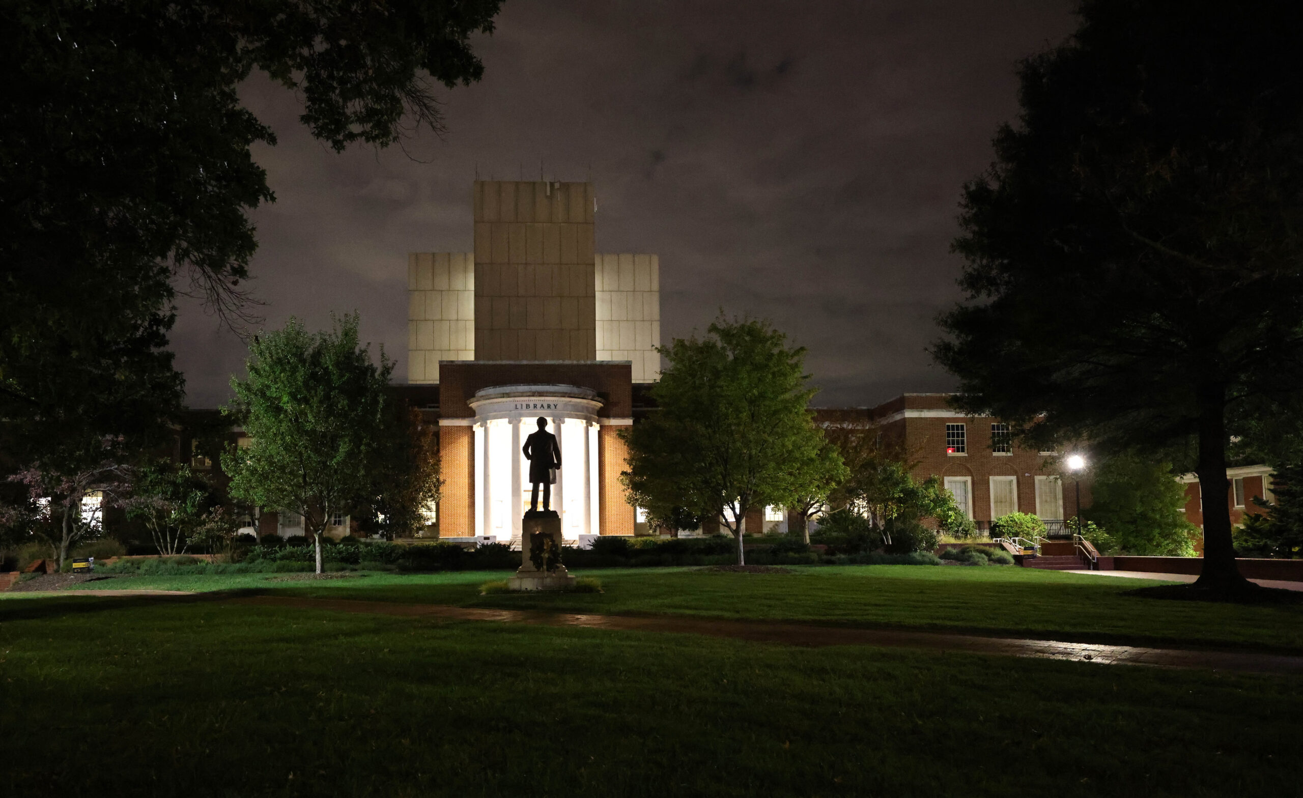 Statue of Charles Duncan McIver and Jackson Library at night