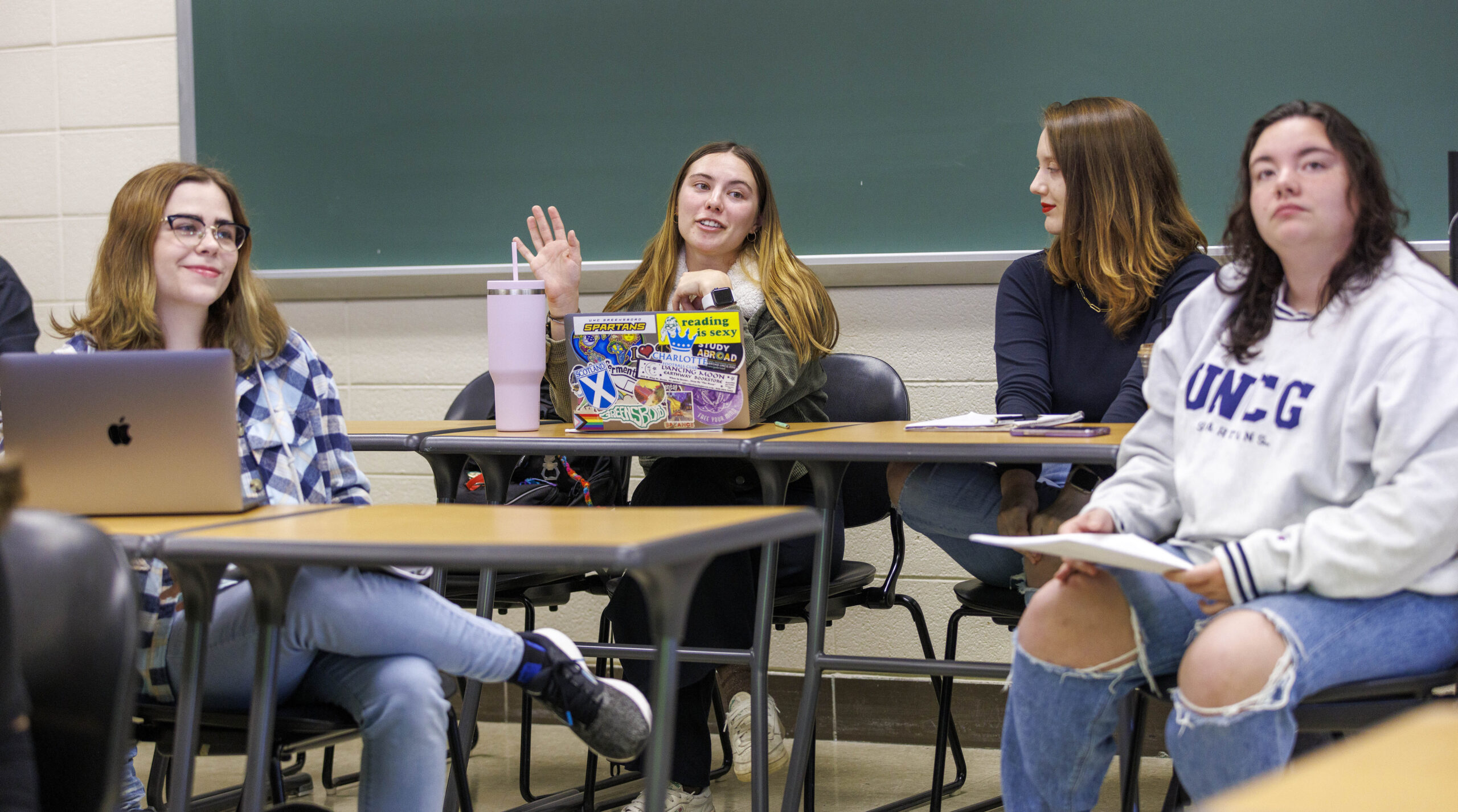 Four students sitting at desks