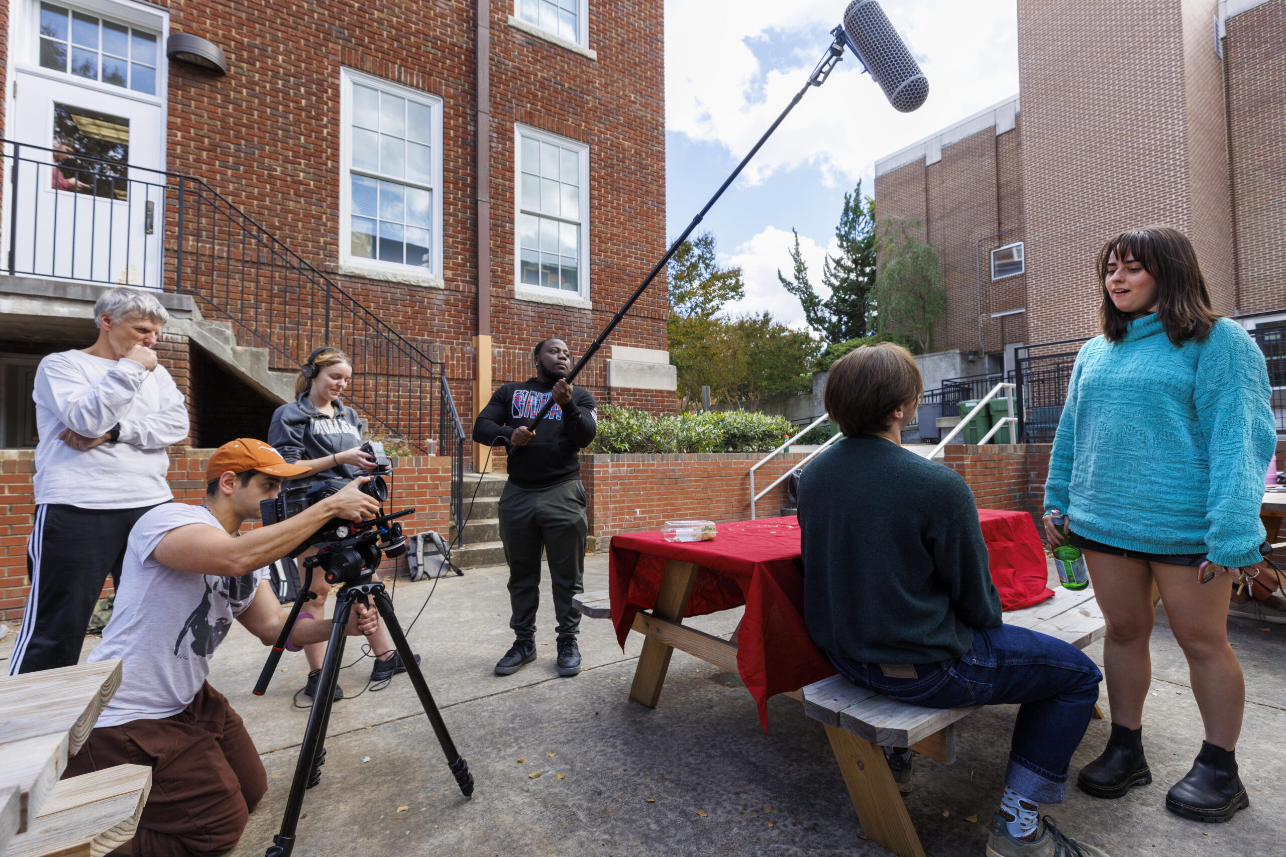 A group of UNCG film students stage a scene with a camera and a mic.