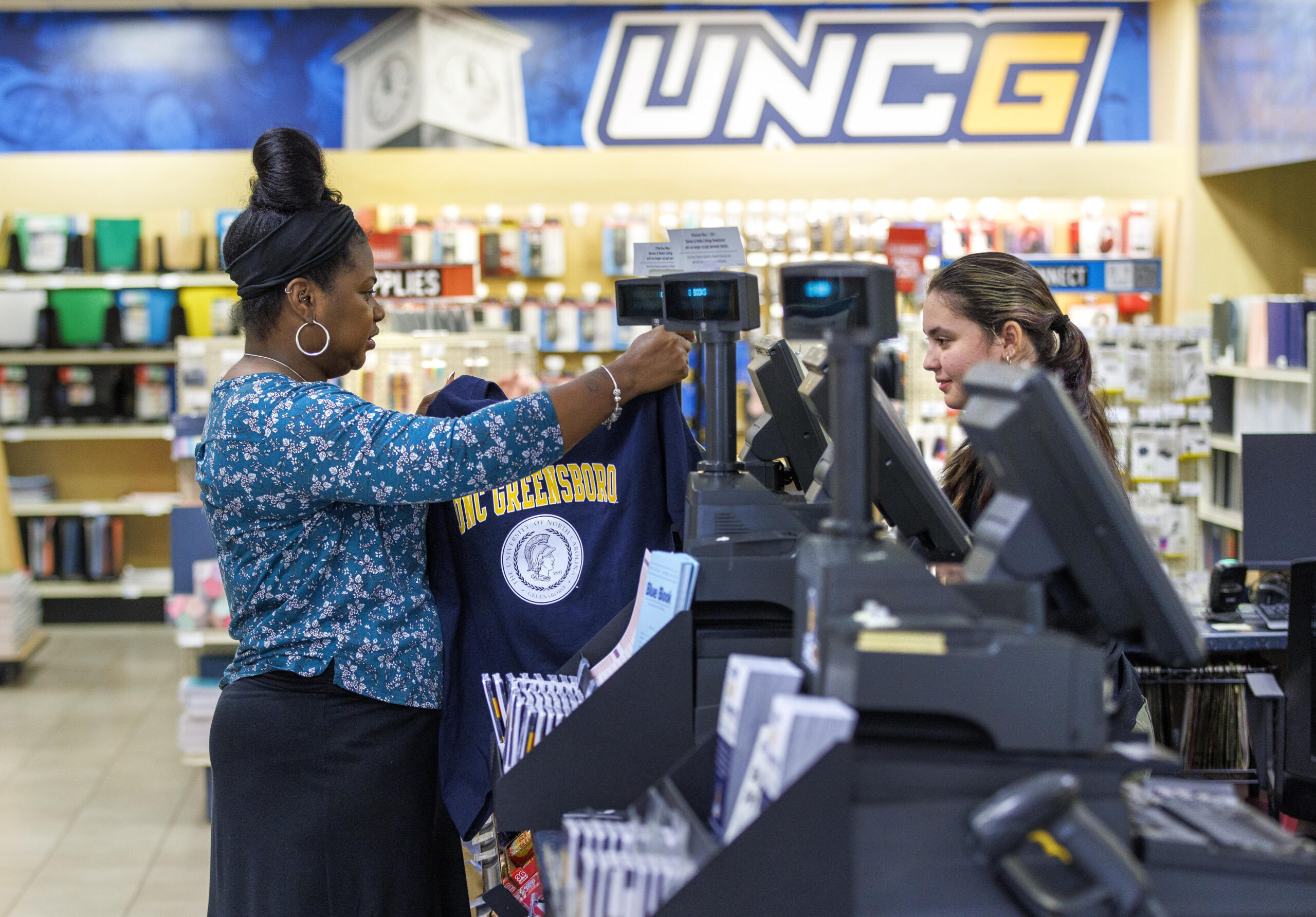 Alumna shops in UNCG bookstore before homecoming weekend.