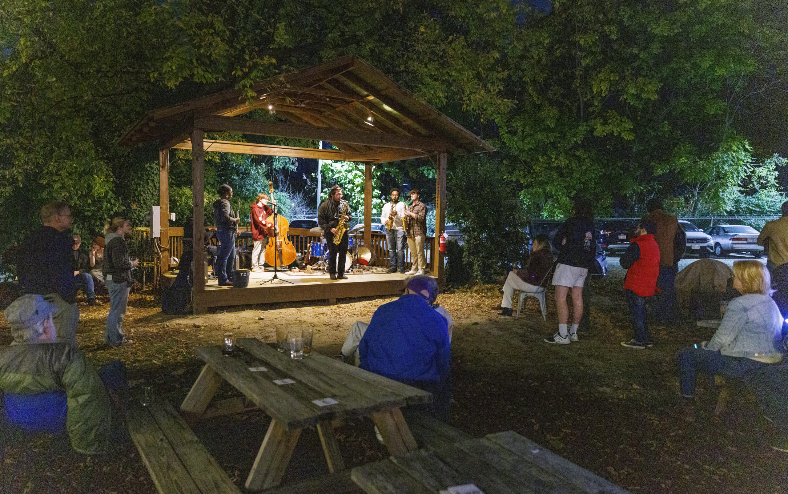 A group of UNCG students play jazz on an outdoor stage.