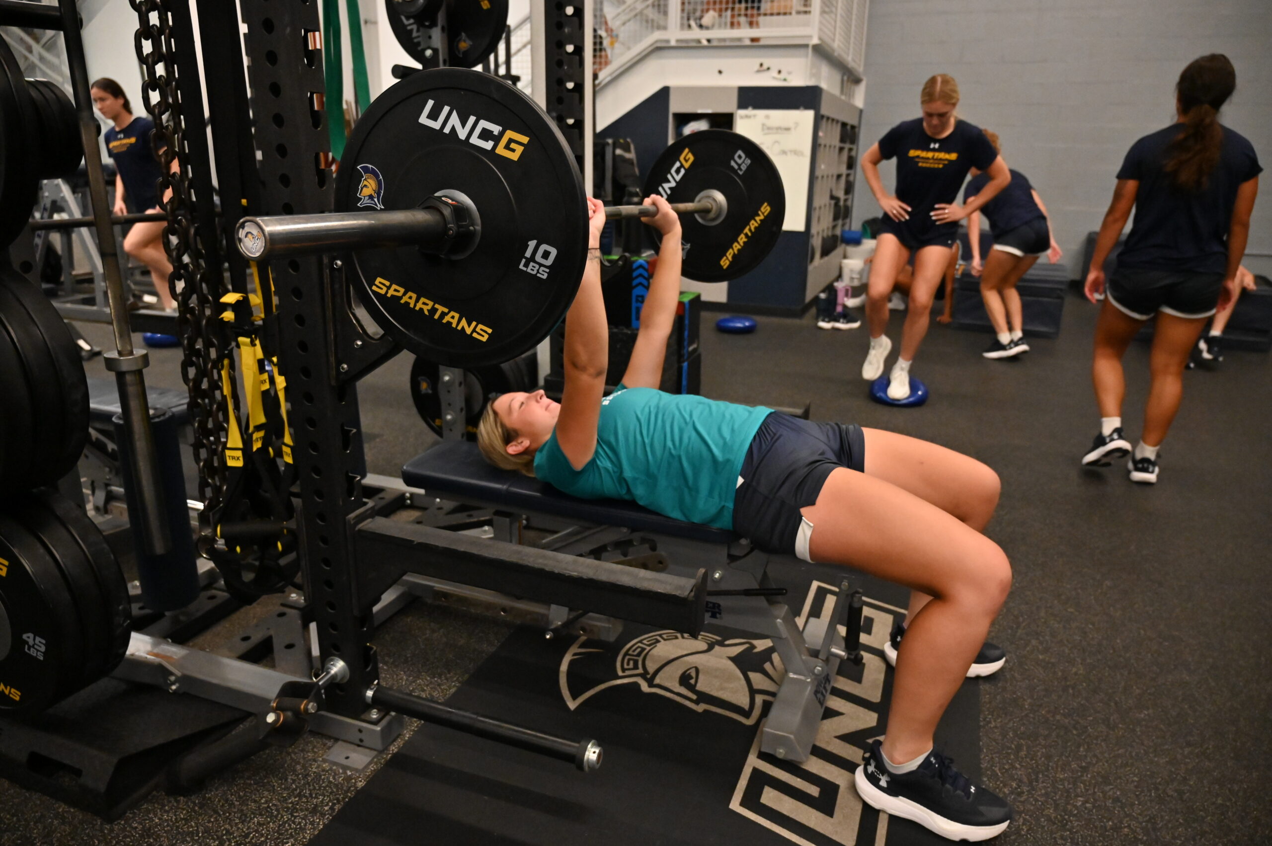 Students exercise in the weight room at Bodford Strength Training Center - Coleman Building.