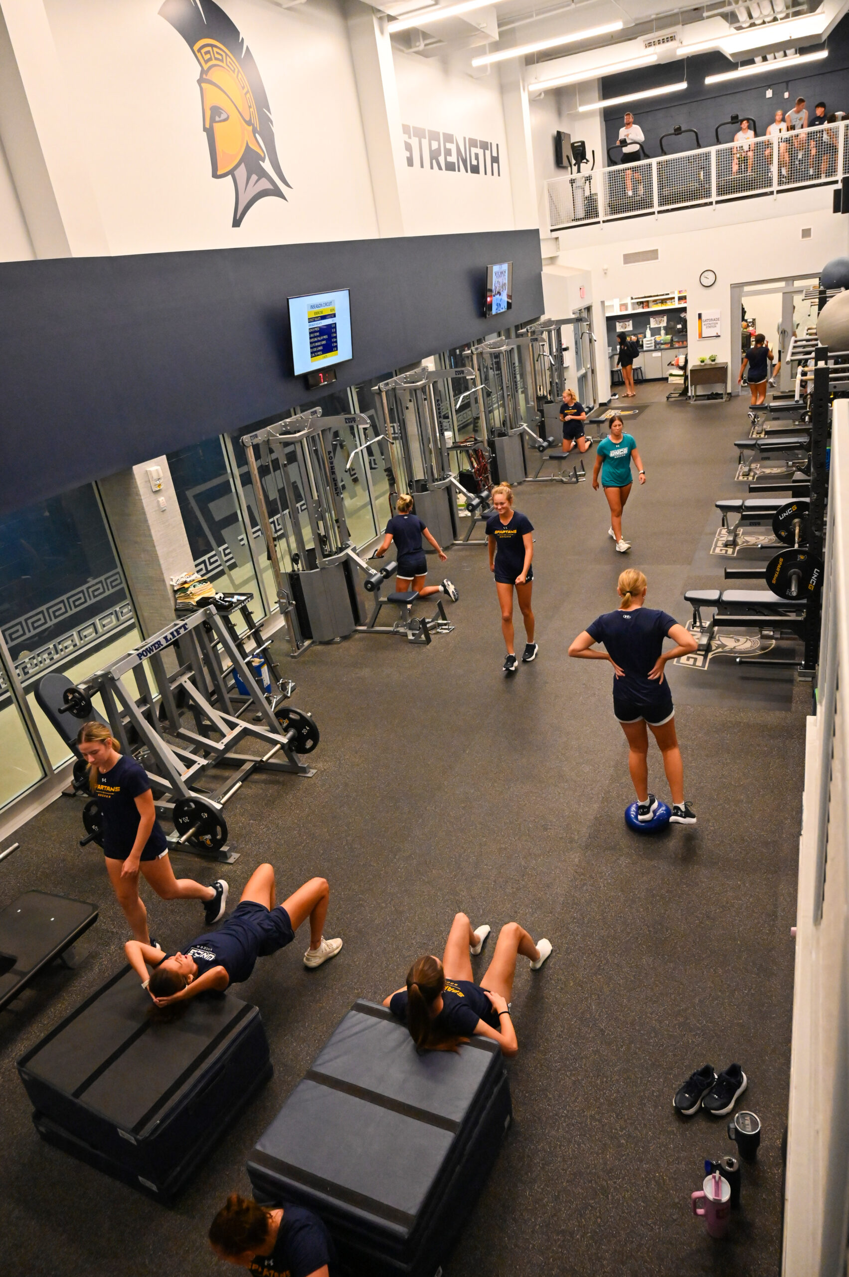 Student athletes exercise in the Bodford Strength Training Center - Coleman Building.