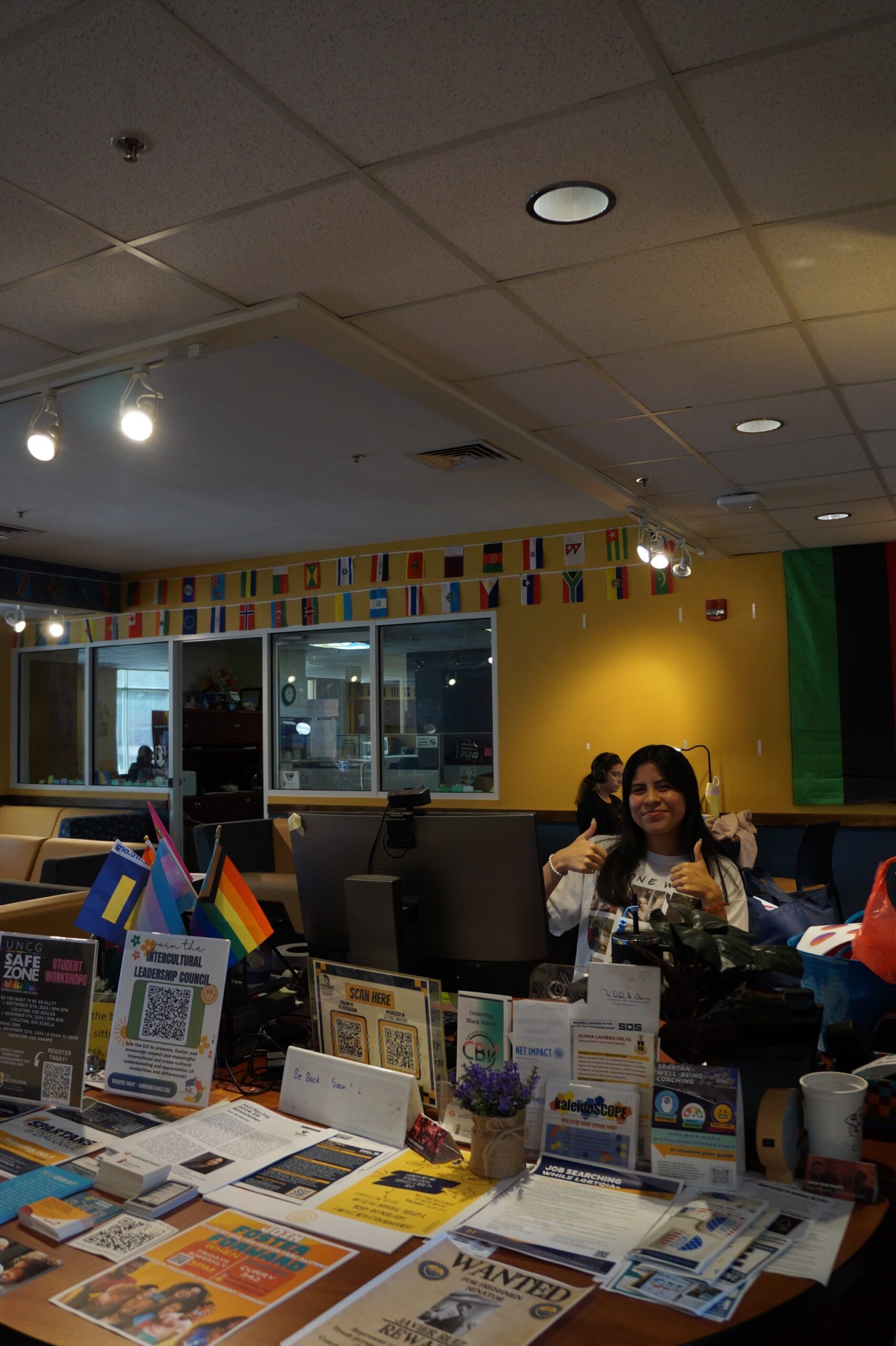 A student at the Jackson Library reaching for a book. She's focused on finding a good read.