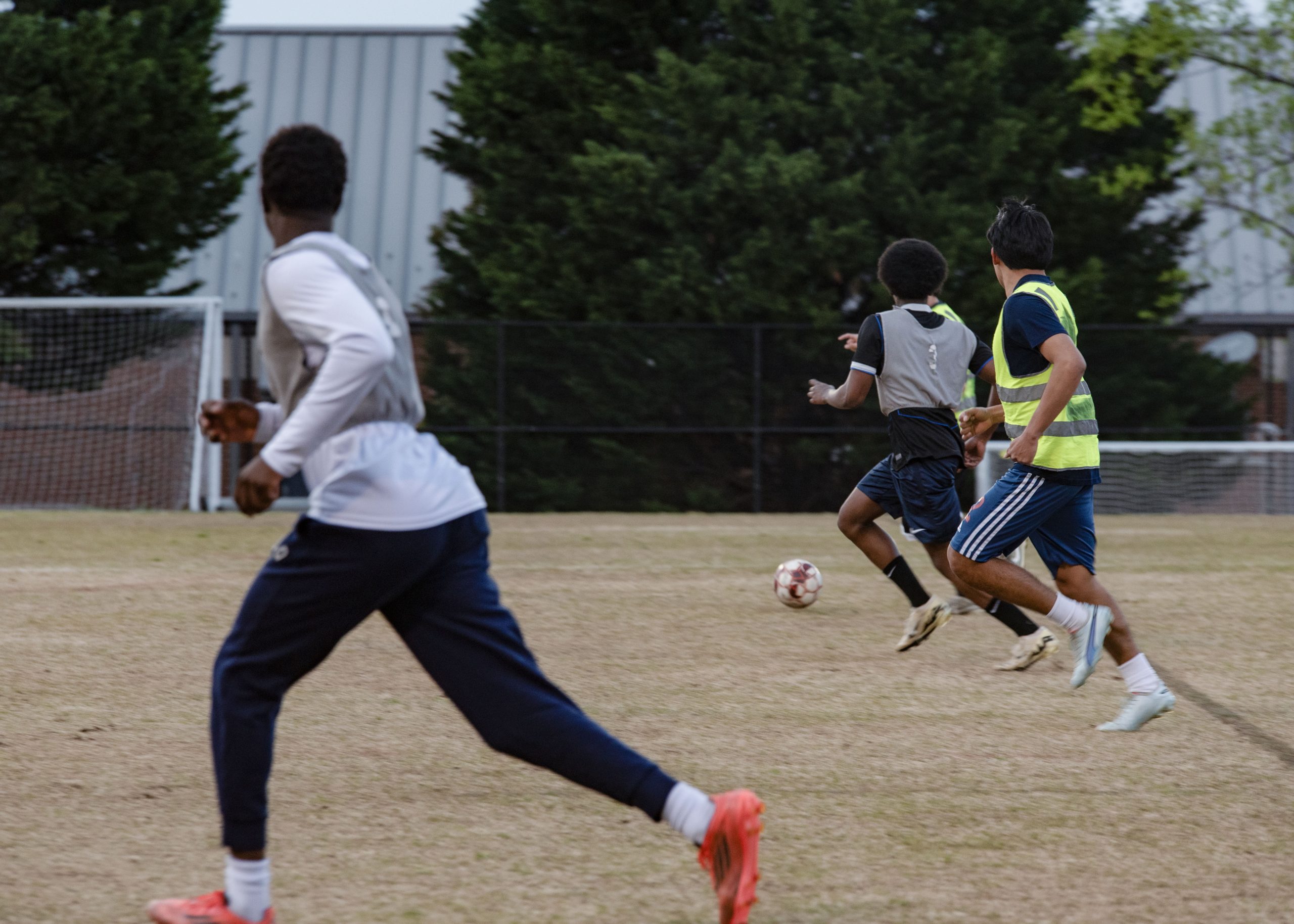 Students playing a friendly competitive soccer game for Sports Global Jersey Night.