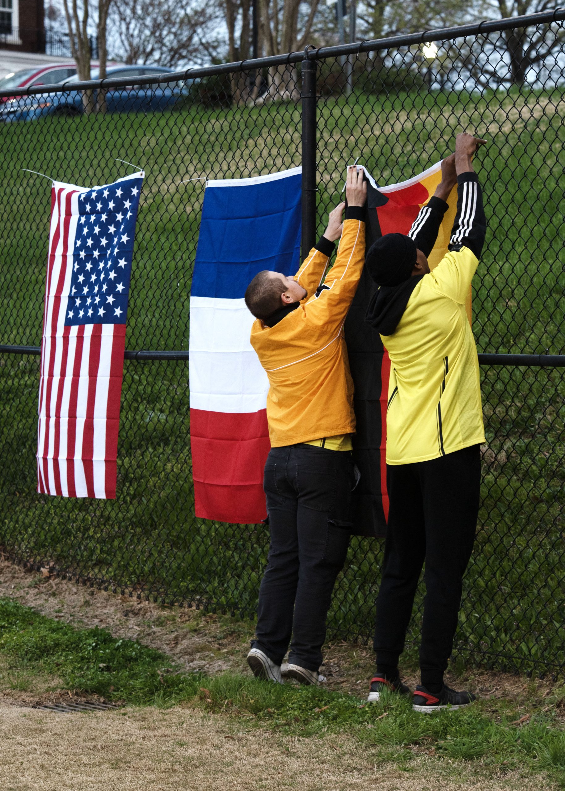 Spartans get ready for Sports Global Jersey Night by hanging up flags from around the world