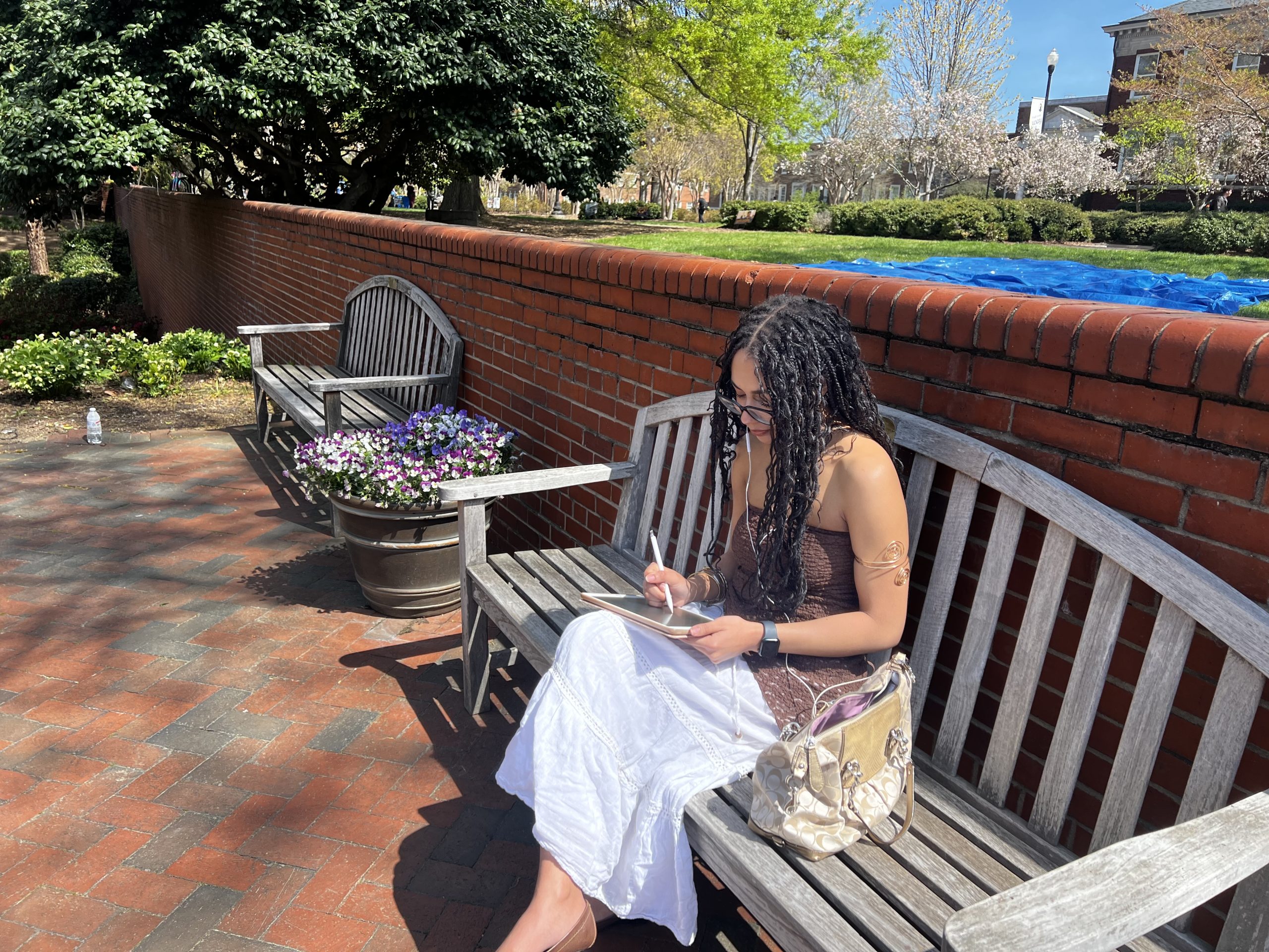 A student hones her drawing skills on one of the Minerva benches.