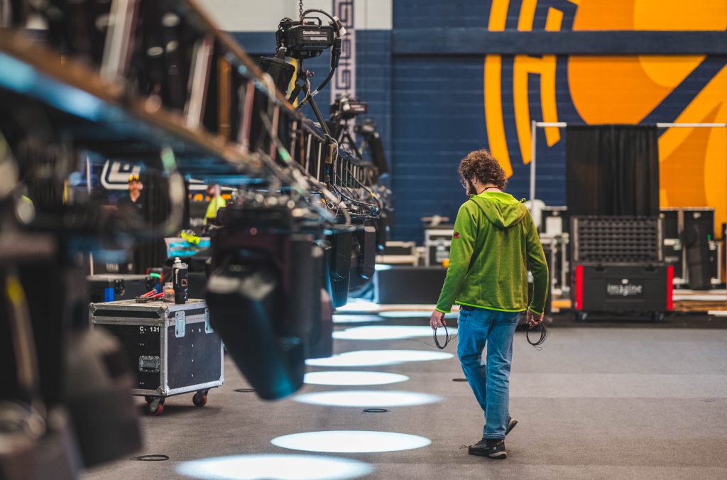 A behind the scenes moment as University Advancement sets up at Coleman for the Light The Way Close grand event.