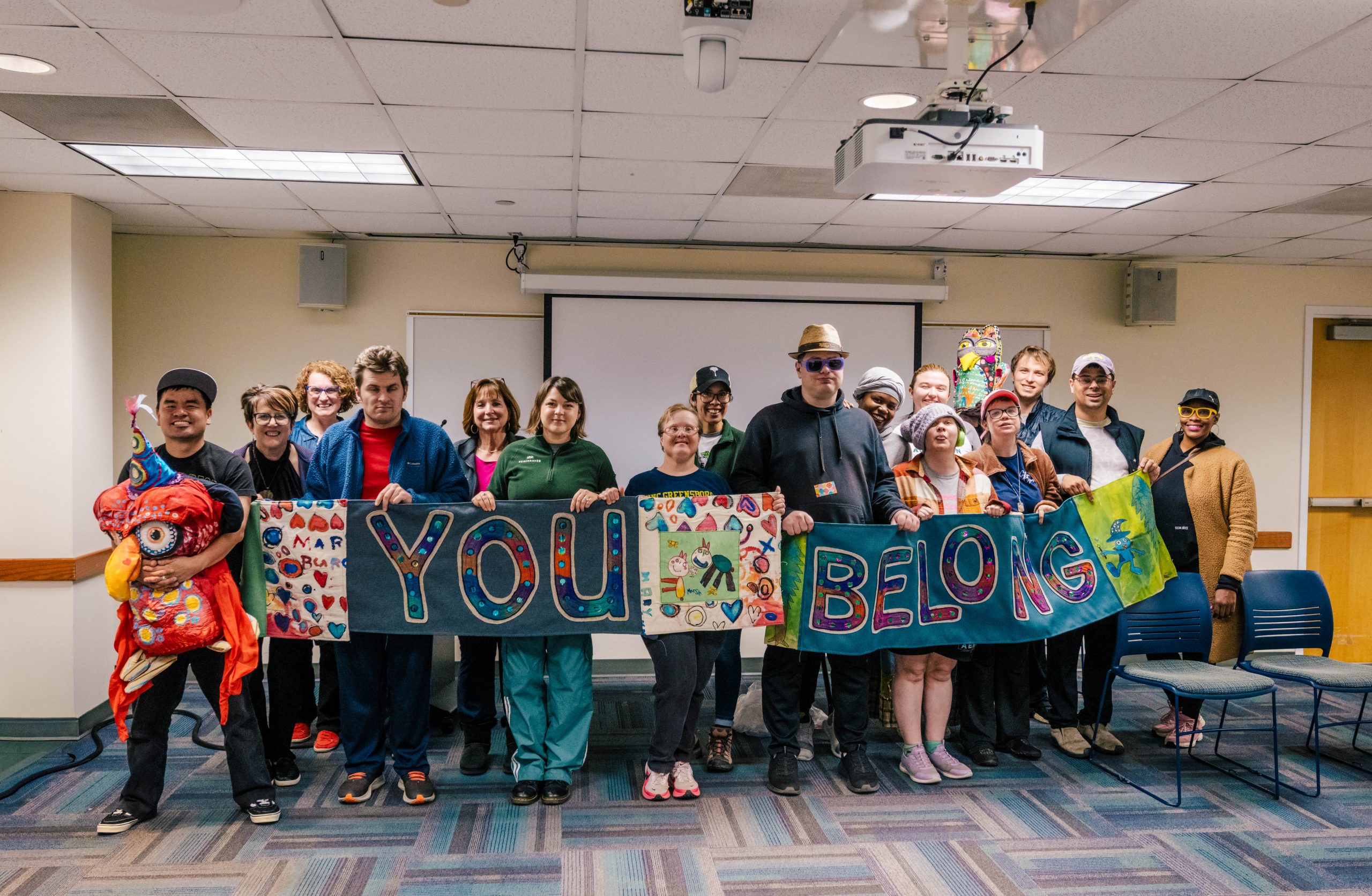 Students show off the quilt they made for the Harriet Elliott Lecture Series presentation on art and connection.