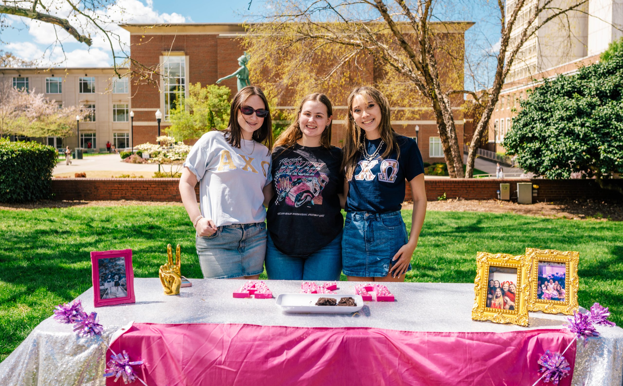 Alpha Ki Omega Sorority work on recruiting new members in front of Minerva Statue on College Ave.