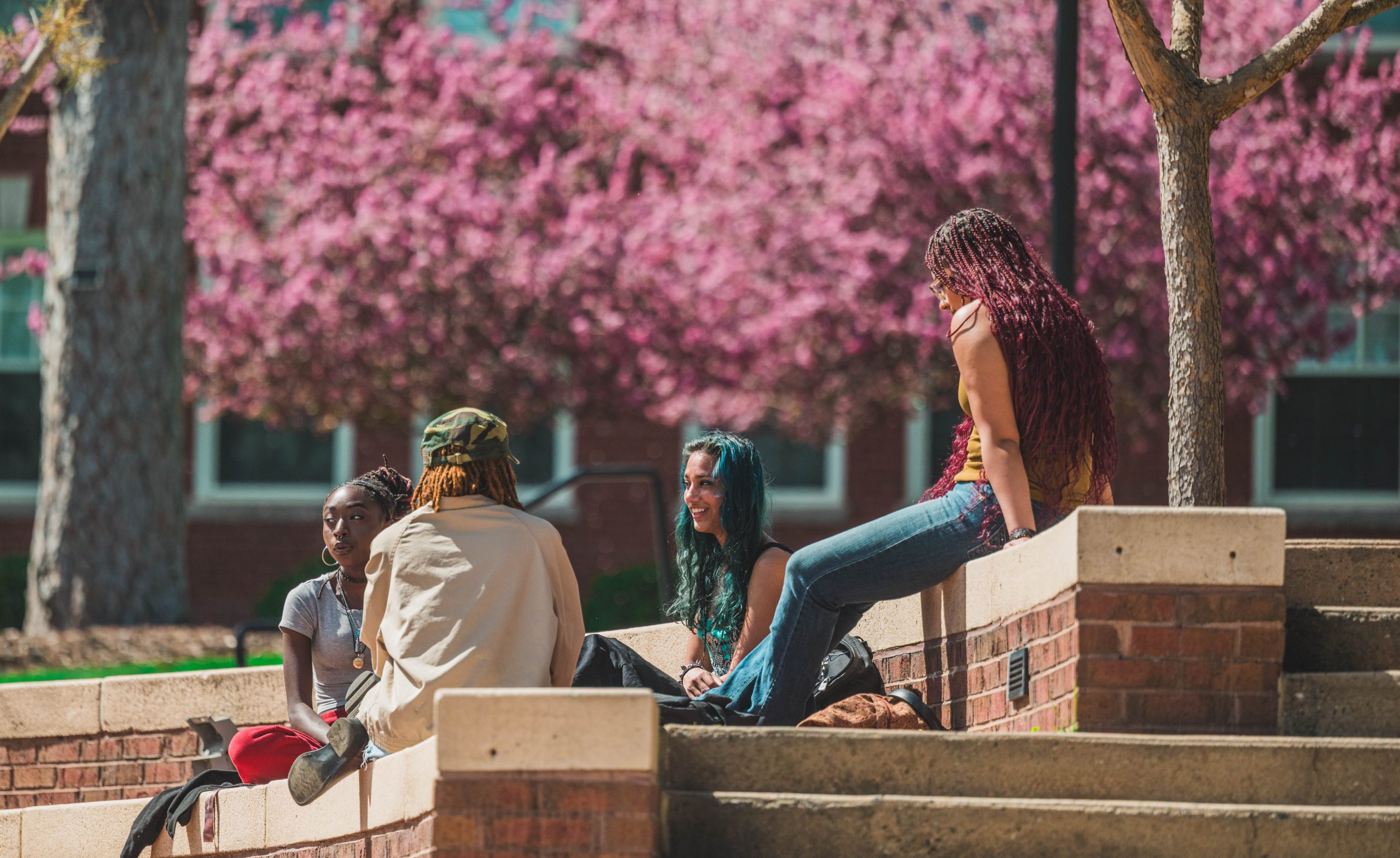 Students hanging out at Moran Commons during lunch time by The Fountain.