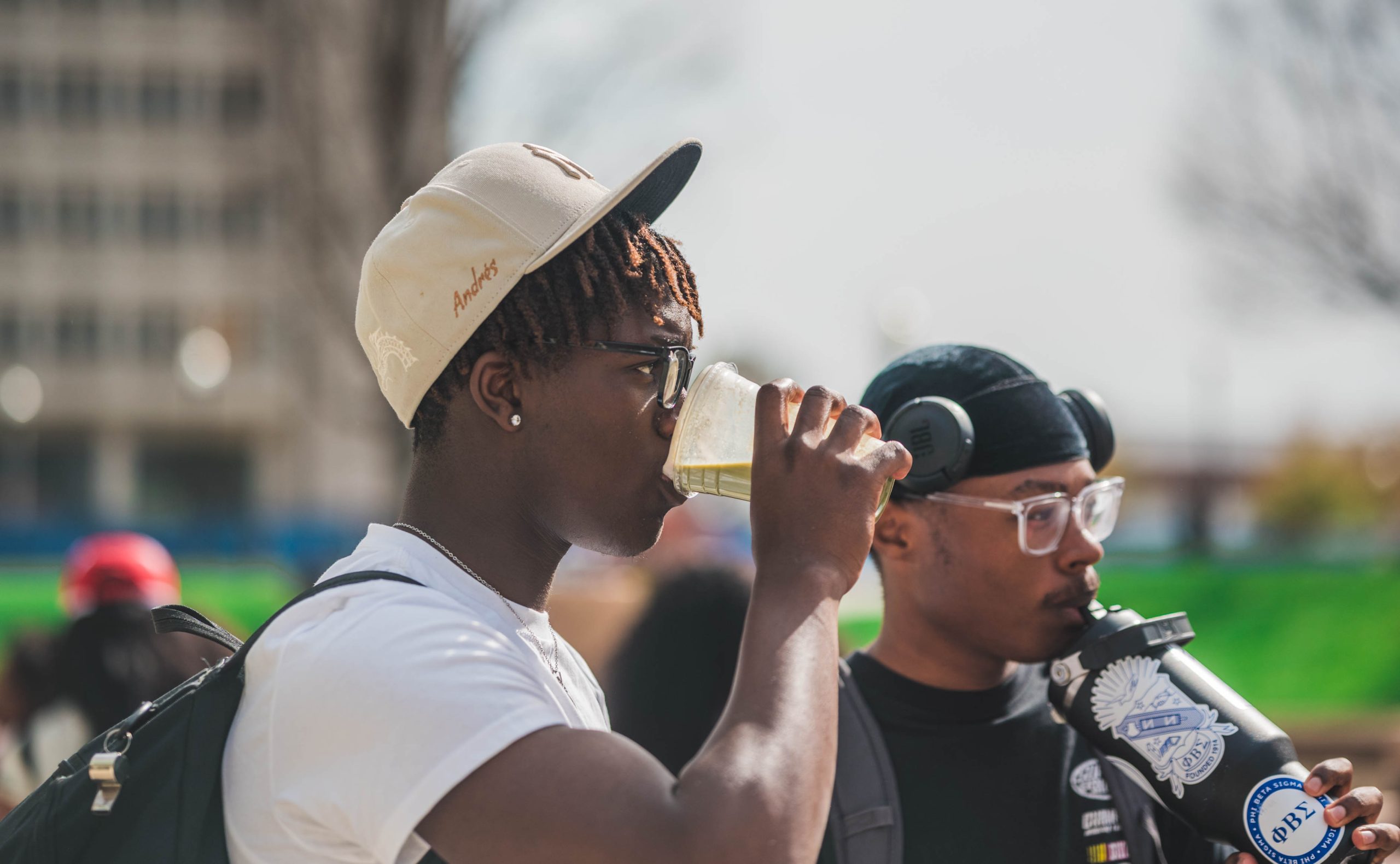 Two students have a refreshing beverage courtesy of the food truck at the Fem Fam Fun event at "The Fountain" at Moran Commons.