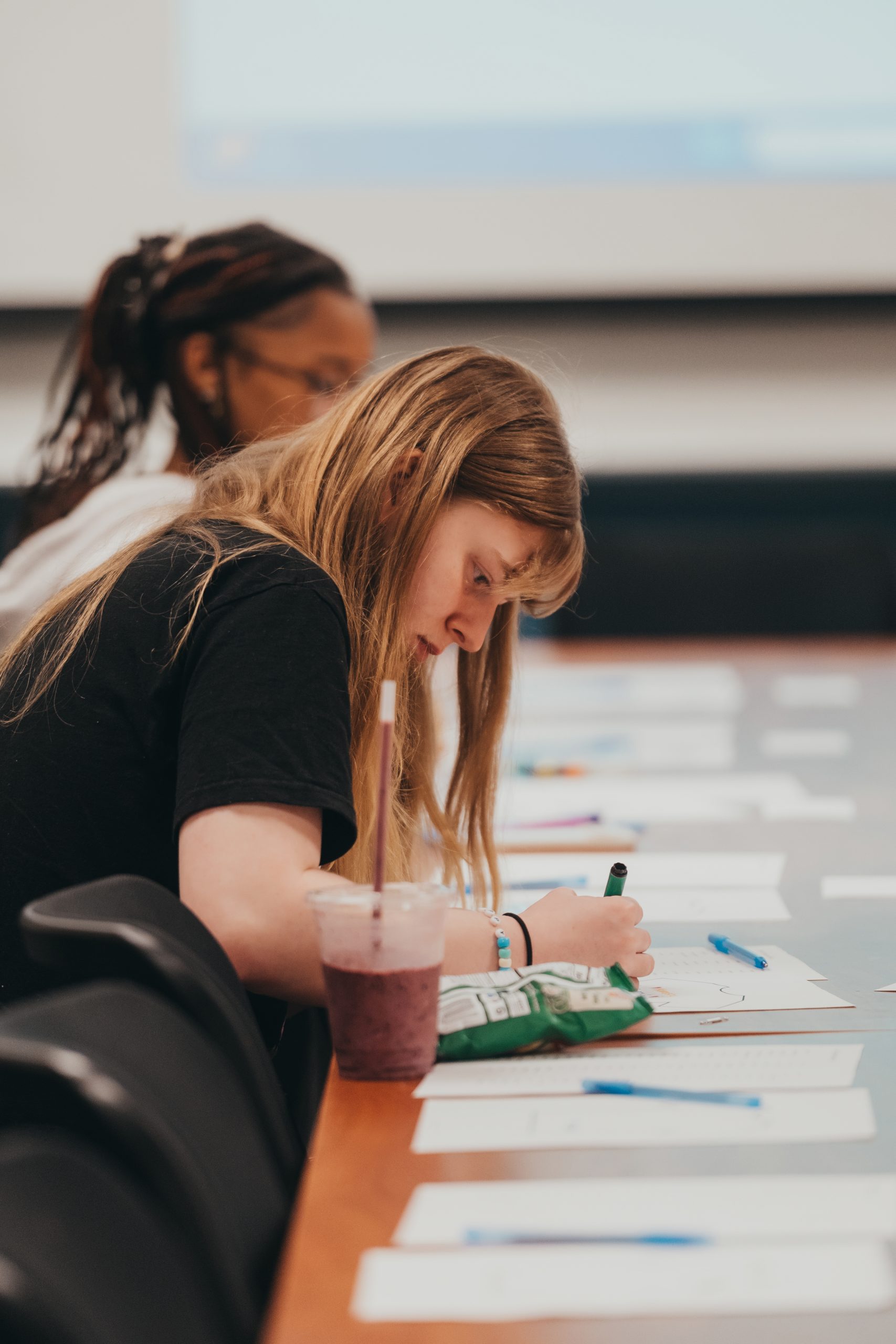 A student participants in the YFY Student Success Series, which offers co-curricular programs and events for students to develop a strong foundation for academic and personal success during their first year at UNCG, participates in a writing activity.