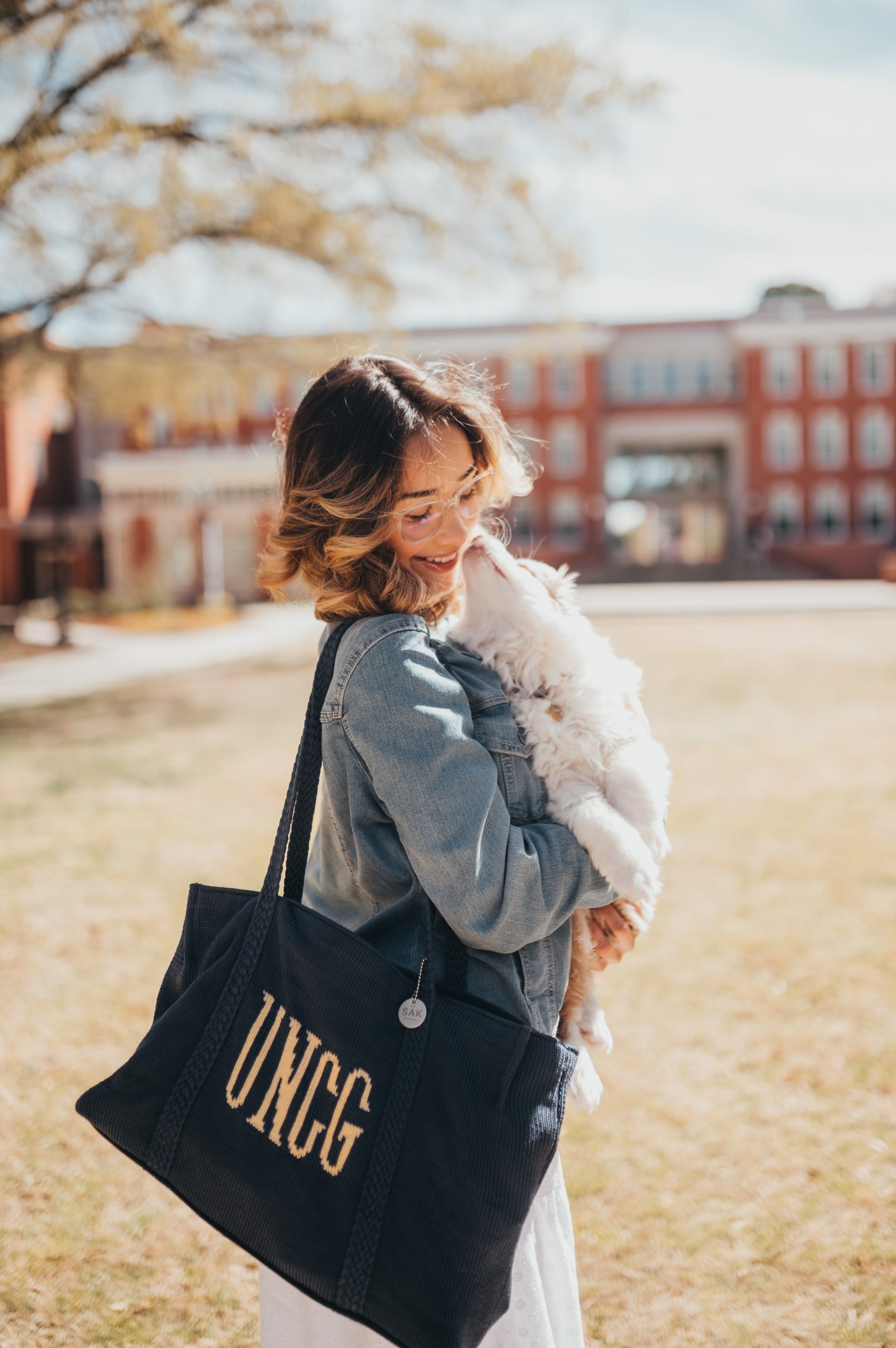 A Spartan has fun on campus with her puppy
