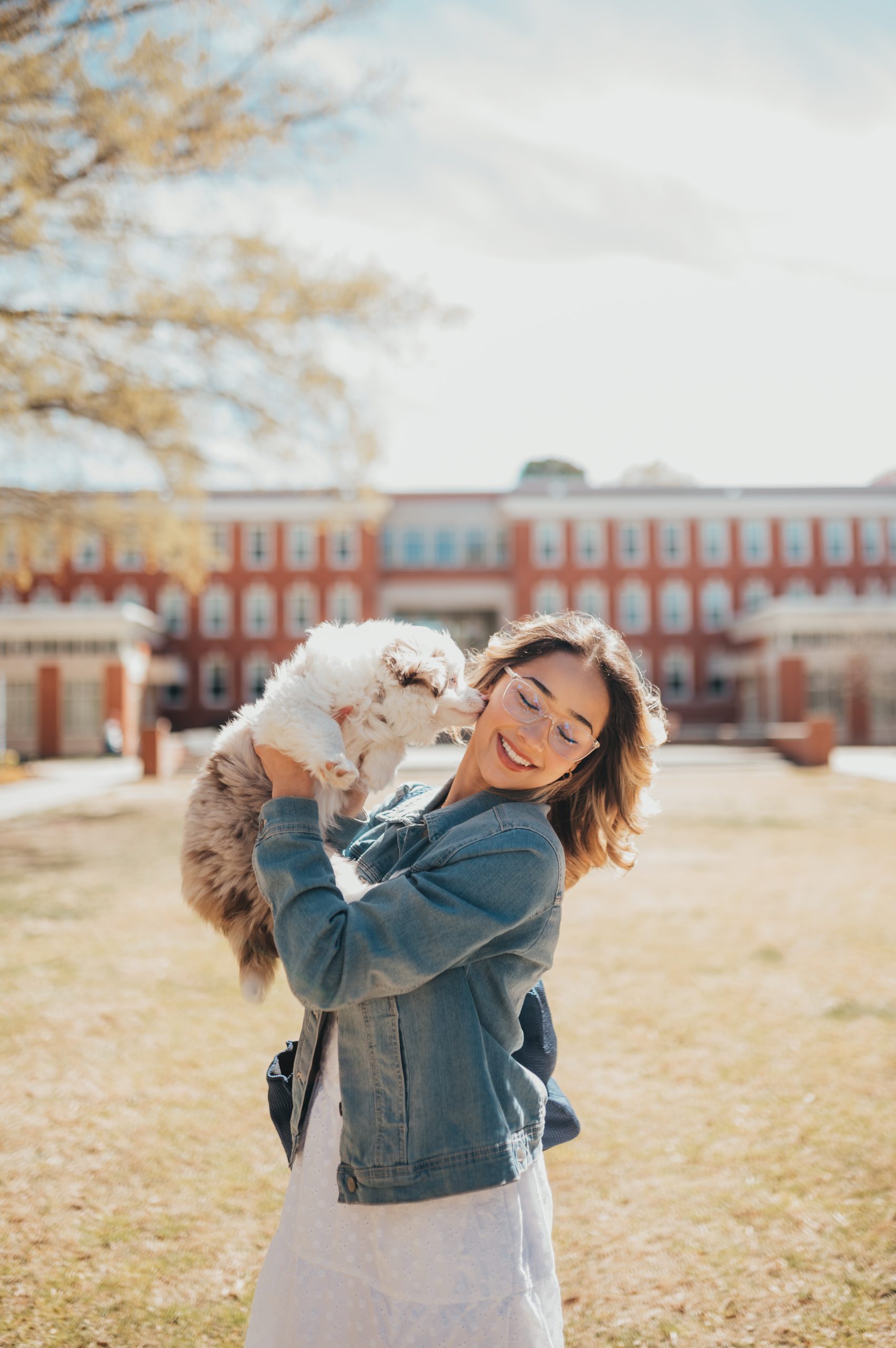 A Spartan has fun on campus with her puppy